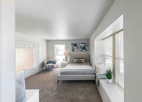 a bedroom with a bed and a large window