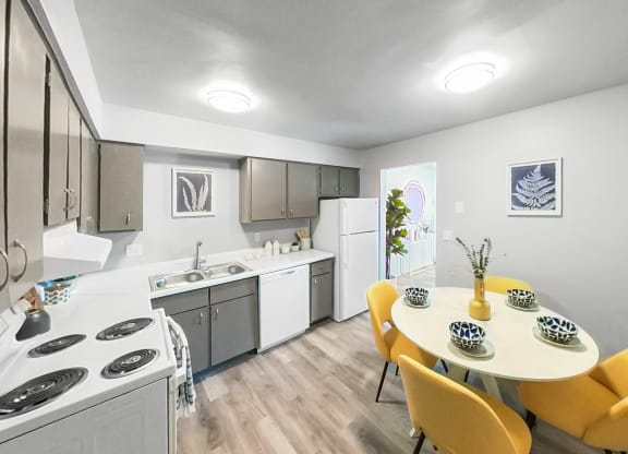 a kitchen and dining room with a table and chairs