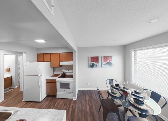 the living room and dining room of an apartment with a table and chairs
