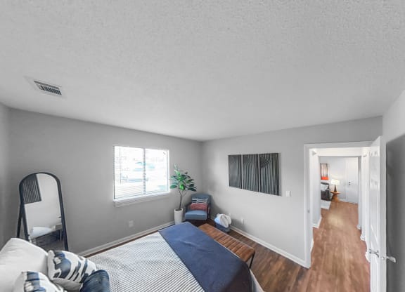 a bedroom with a bed and a mirror on the wall
