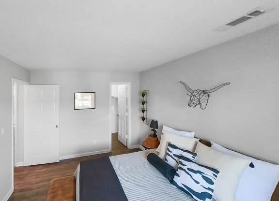 a bedroom with a bed and a door to a closet