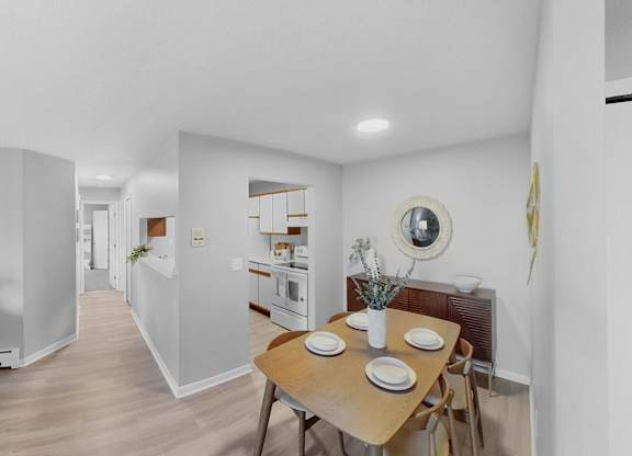 a dining room and kitchen with a table and chairs