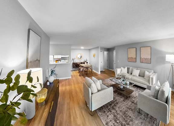 a living room with couches and chairs and a rug