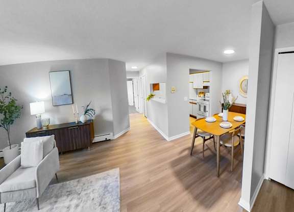 a living room and dining room with a table and chairs