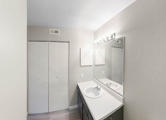 an empty bathroom with a sink and a mirror
