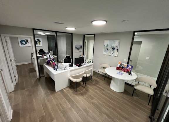 A room with a desk and chairs.