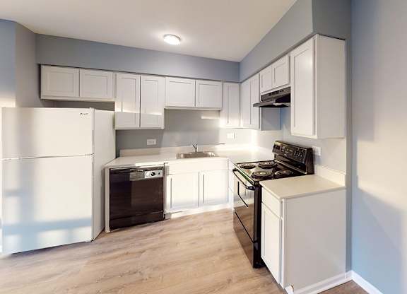 a kitchen with white cabinets and a stove and a refrigerator