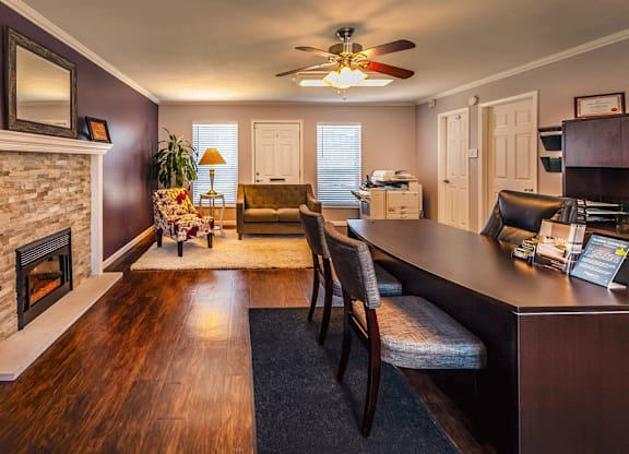 a living room with a fireplace and a dining table