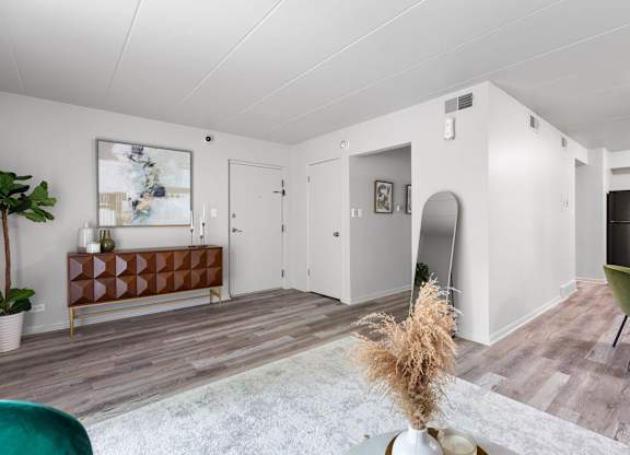 a living room with white walls and wooden floors