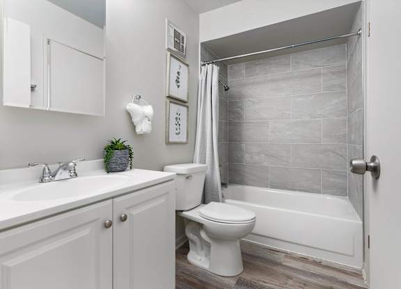 a white bathroom with a shower and a toilet