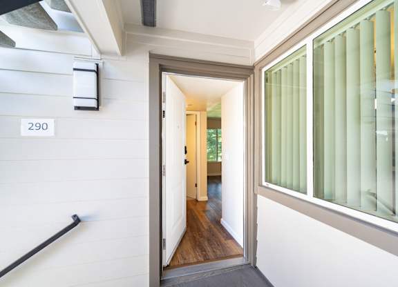 A hallway with a door numbered 290.