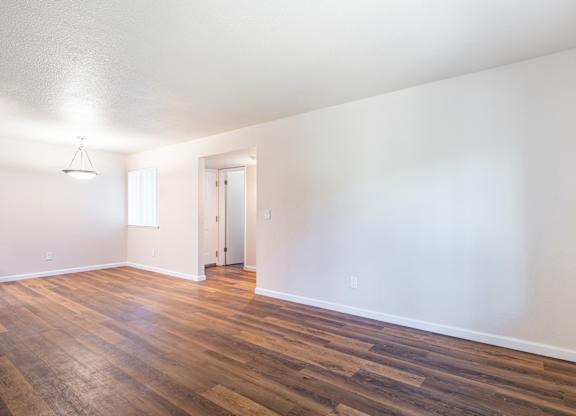 A room with wooden floors and white walls.