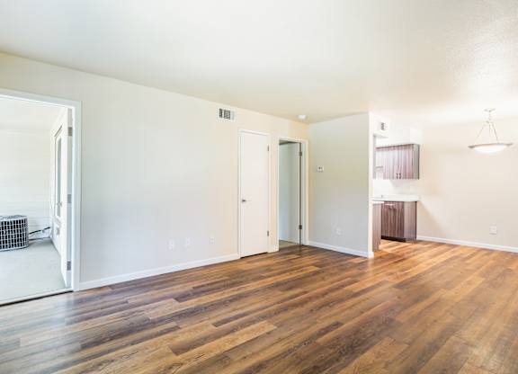 A room with wooden floors and white walls.