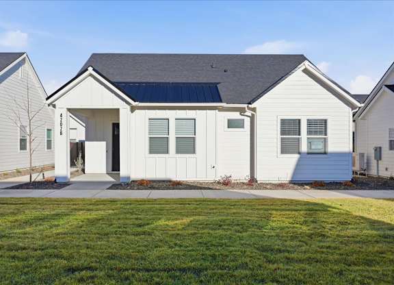 House with a grey roof and a solar panel at Alante Homes at Spring Run, Idaho, 83607