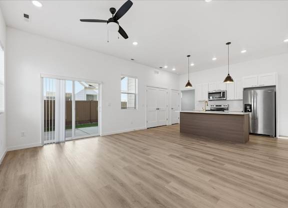 Living room with sliding door at Alante Homes at Spring Run, Idaho, 83607