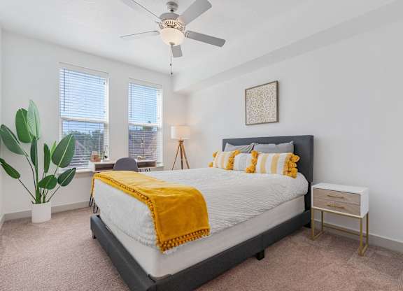 a bedroom with a bed and a ceiling fan at City View St. George Apartments, Utah