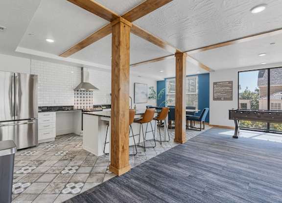 an open kitchen and dining area with a bar and a pool table at City View St. George Apartments, St George