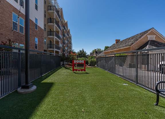 the yard is fenced in with a table and chairs on the grass at City View St. George Apartments, St George, Utah