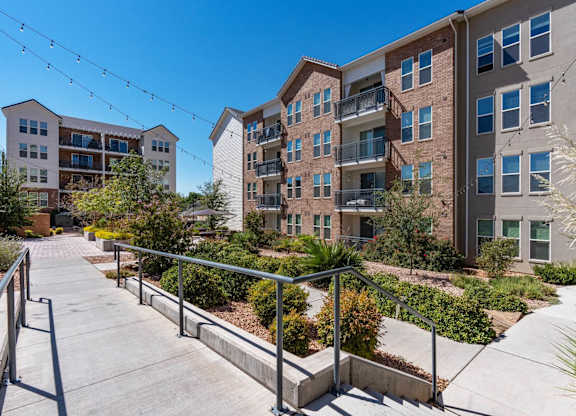 steps leading up to an apartment building with stairs and landscaping at City View St. George Apartments, Utah