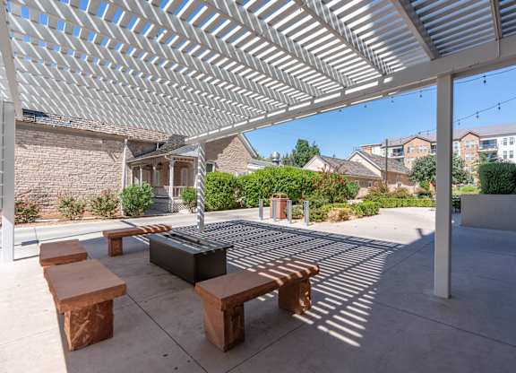 a covered patio with benches and a fire pit at City View St. George Apartments, Utah, 84770