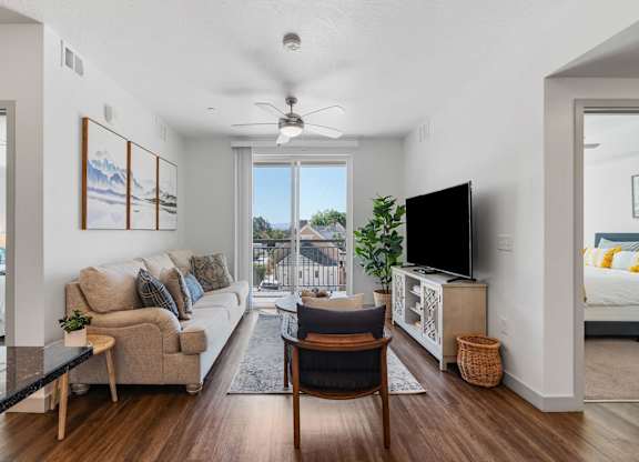a living room with a couch and a chair and a tv at City View St. George Apartments, St George, UT, 84770