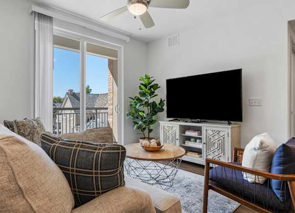 a living room with a couch and a tv at City View St. George Apartments, St George