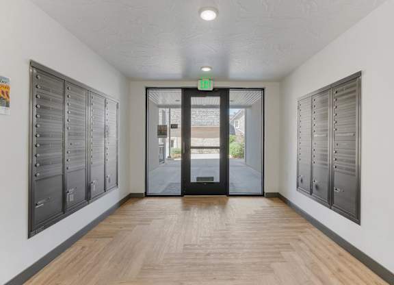 a hallway with lockers and a door to a building at City View St. George Apartments, St George, Utah