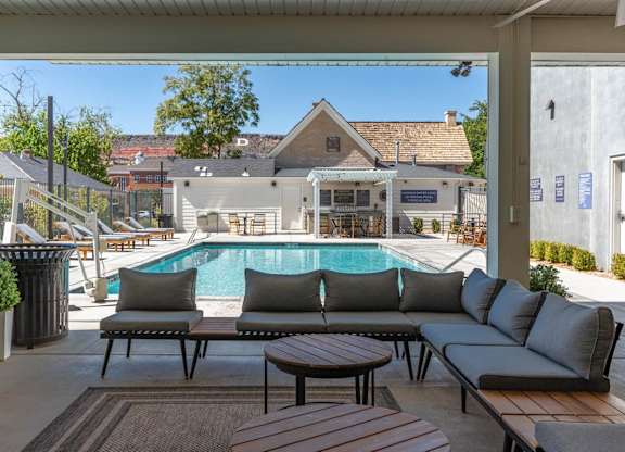 a swimming pool is seen from a patio with couches and tables at City View St. George Apartments, Utah, 84770