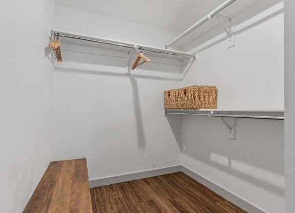 a walk in closet with white walls and a wood floor at City View St. George Apartments, St George, UT, 84770