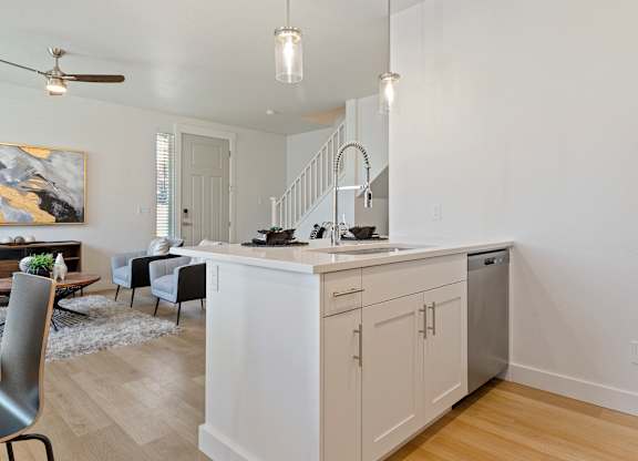a kitchen and living room with a staircase at Alante Homes at Lake Hazel, Idaho, 83709