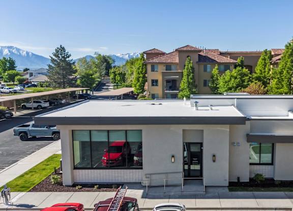 A modern house with a red car parked in front. at Siena Villas Apartments, Orem, Utah