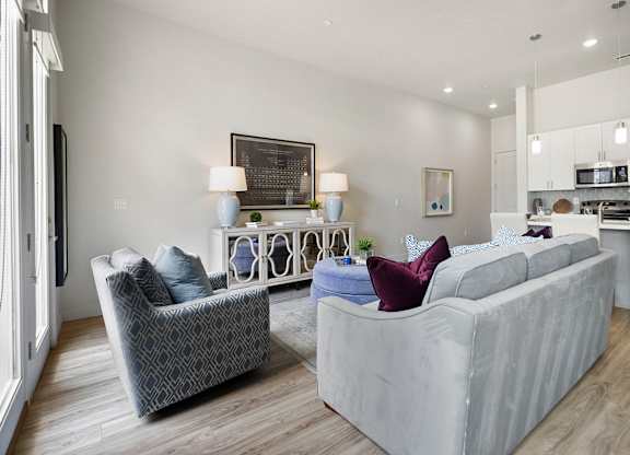 a living room with two couches and two chairs and a kitchen in the background at 200 City View, Provo, 84601
