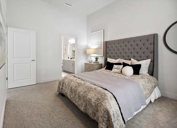 a bedroom with a bed and a door to a bathroom at 200 City View, Utah