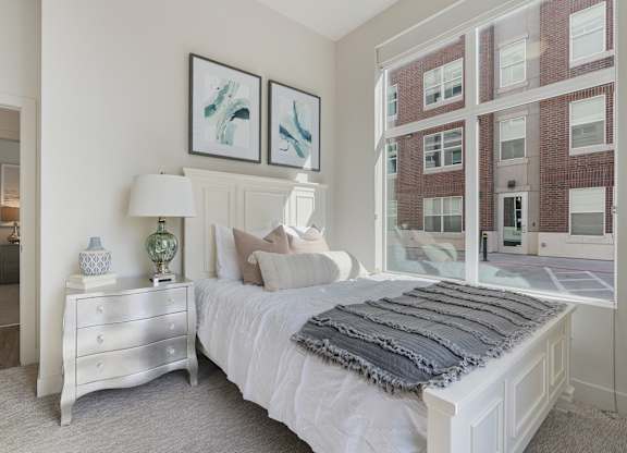 a bedroom with a bed and a large window at 200 City View, Provo