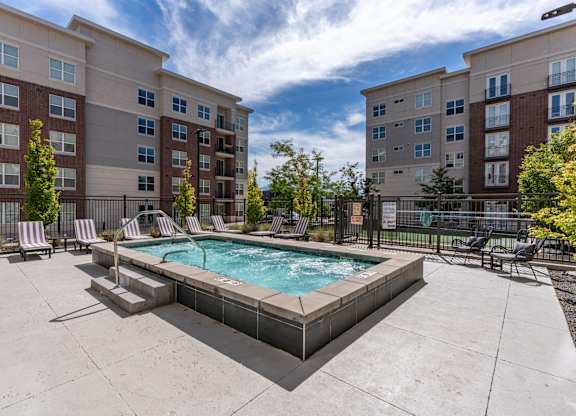 our apartments have a resort style spa with lounge chairs and an apartment building at 200 City View, Provo, Utah