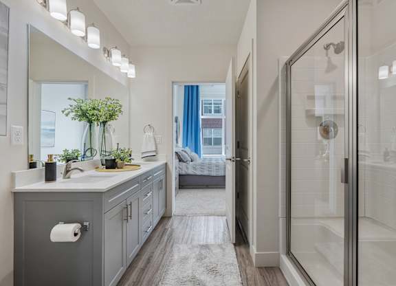 a bathroom with a shower and a sink and a mirror at 200 City View, Utah
