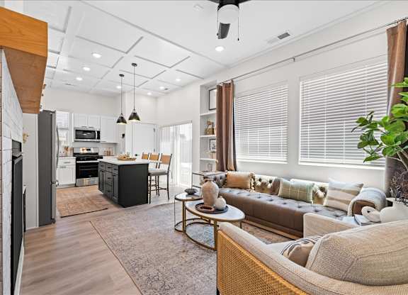 A modern living room with a brown sofa and a wooden coffee table.at Alante Homes at Spring Run, Idaho