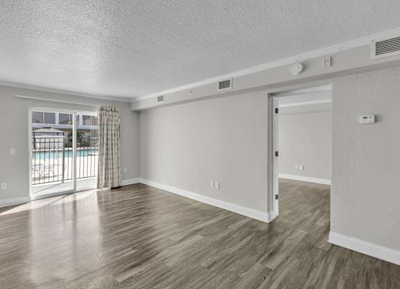 Room with sliding glass door at Avia Apartments at Reedy Creek, Kissimmee, FL