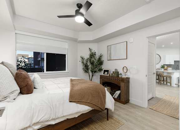 A bedroom with a large bed and a ceiling fan. at The Vue At Desert Color, St. George, Utah