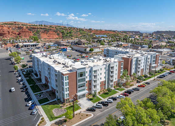 A view of a city with cars on the road and apartment buildings 605 Place Student Housing & Co-Living, St George Utah