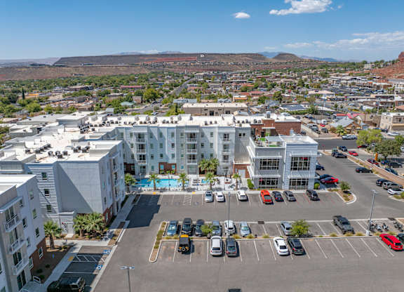 A parking lot with cars and a building in the background. 605 Place Student Housing & Co-Living, Utah