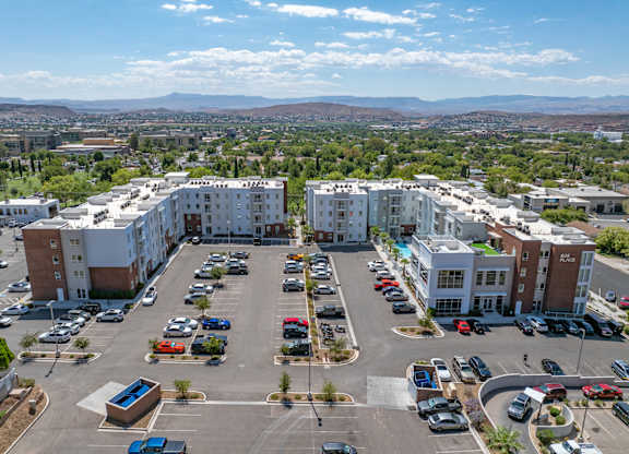 A parking lot with cars and apartment buildings in the background. 605 Place Student Housing & Co-Living, St George Utah