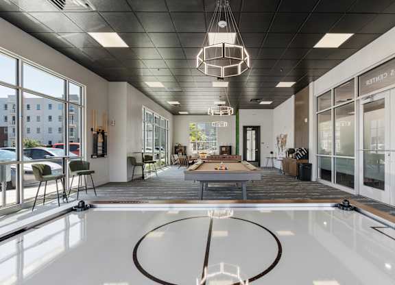 an indoor pool with a ping pong table in a lobby of a building at 605 Place Student Housing & Co-Living, St George, UT