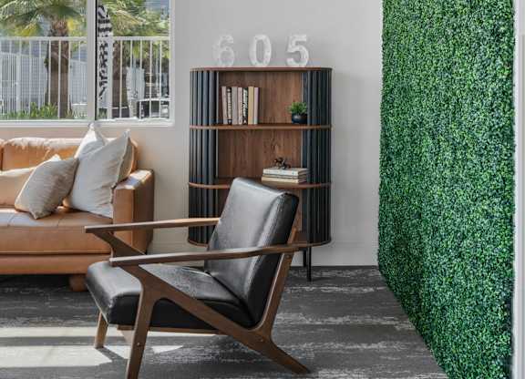 a living room with a green wall and a couch and a chair at 605 Place Student Housing & Co-Living, Utah