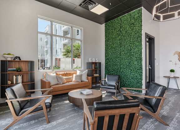 a living room with a couch and chairs and a green wall at 605 Place Student Housing & Co-Living, St George, UT, 84770