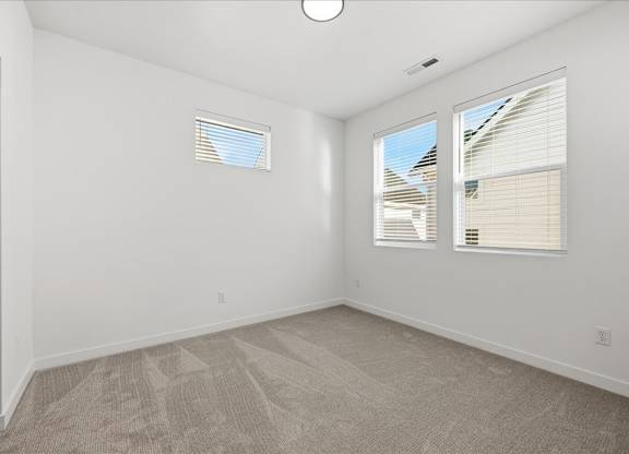 Room with multiple windows at Alante Homes at Spring Run, Caldwell, 83607