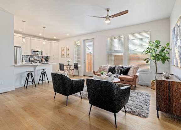 a spacious living room with a kitchen in the background at Alante Homes at Lake Hazel, Idaho
