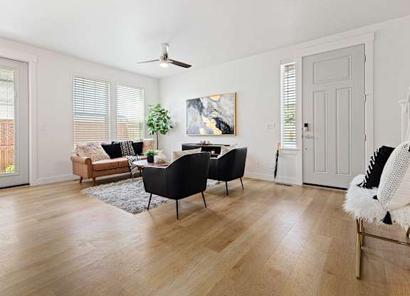 a living room with hardwood floors and white walls at Alante Homes at Lake Hazel, Idaho