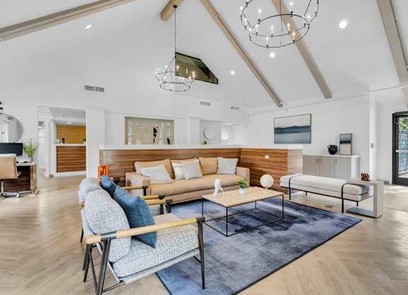 a living room with couches and a coffee table at AVIA Lofts on Liberty Ridge, Jacksonville, FL, 32256