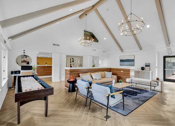 a living room with furniture and a pool table at AVIA Lofts on Liberty Ridge Apartments, Jacksonville 32256